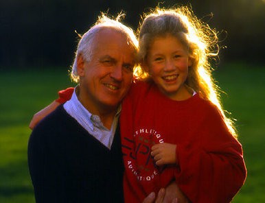 Grandfather and granddaughter posing for picture